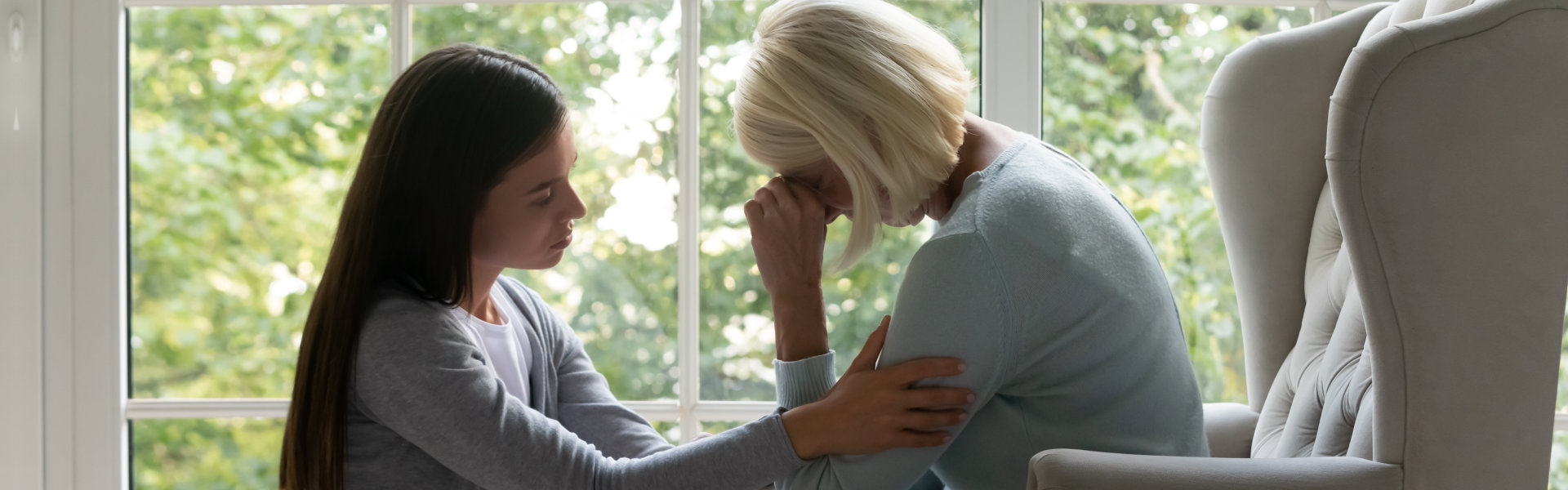 woman comforting elderly woman